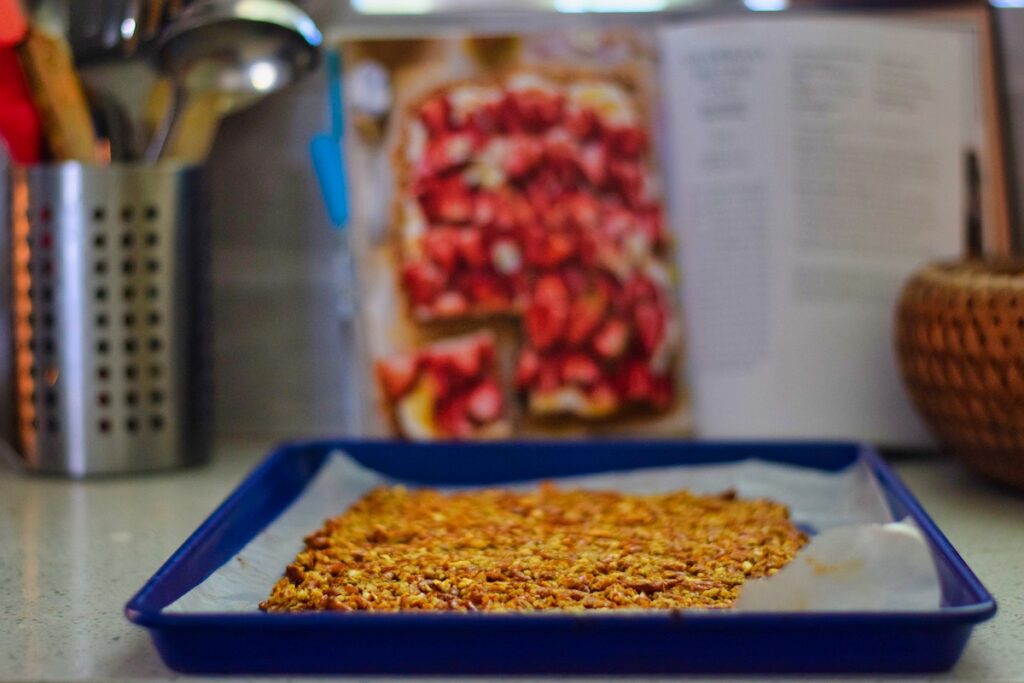 lemony-strawberry-pretzel-treat-crust-with-half-baked-harvest-cookbook-in-background